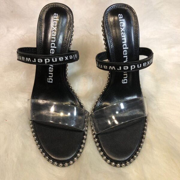I don't know who this is. However, based on the design details, this product is:

AW Amelia Sandals - Heels